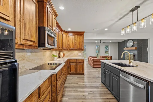 a kitchen with a sink stove and cabinets