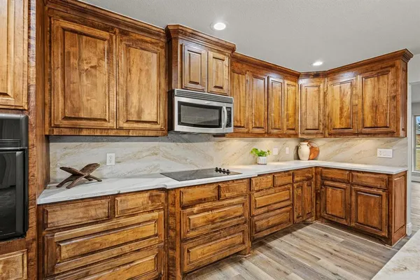 a kitchen with wooden cabinets and a sink