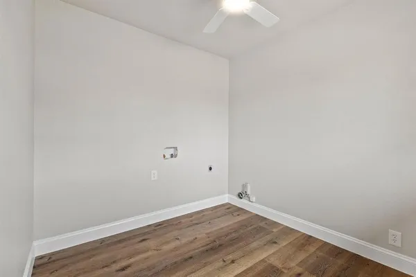 a view of a room with wooden floor