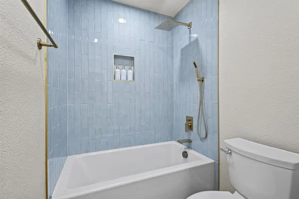 a bathroom with a bathtub and a toilet