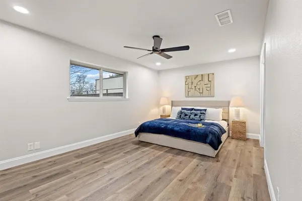 a bedroom with a bed and a painting on the wall