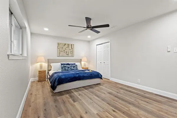 a bedroom with a bed and a ceiling fan