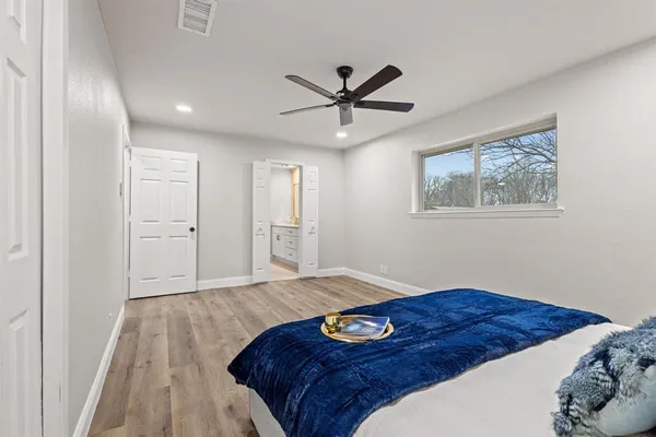 a bedroom with a large bed and a window