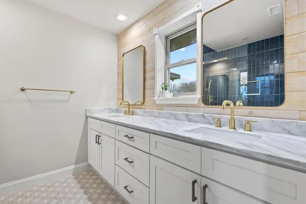 a bathroom with a granite countertop sink mirror and double