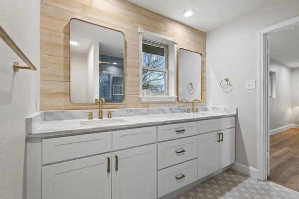 a bathroom with double sink and a mirror