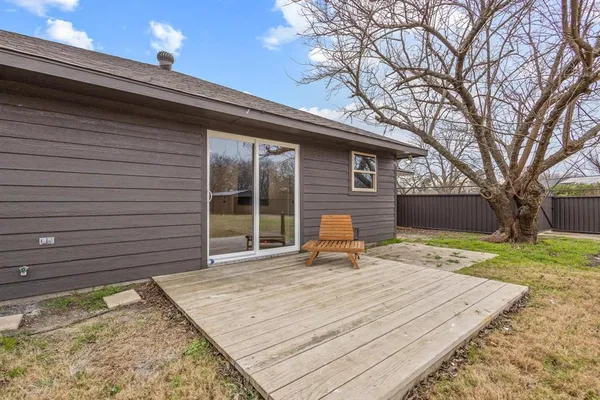a backyard of a house with table and chairs