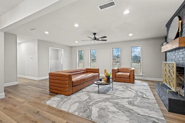 a living room with furniture a fireplace and a flat screen tv