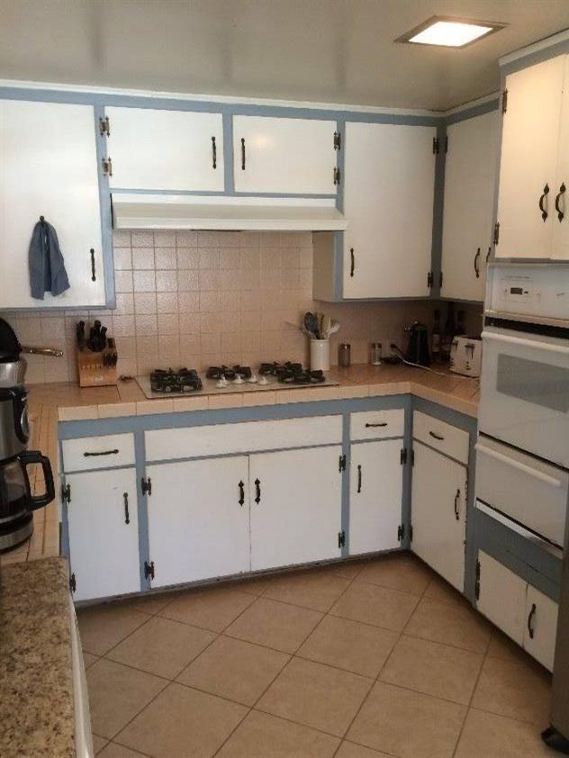 114 Burnham Road Oak View, CA 93022 - Photo 3 of 4 a kitchen with cabinets appliances a sink and a counter top space