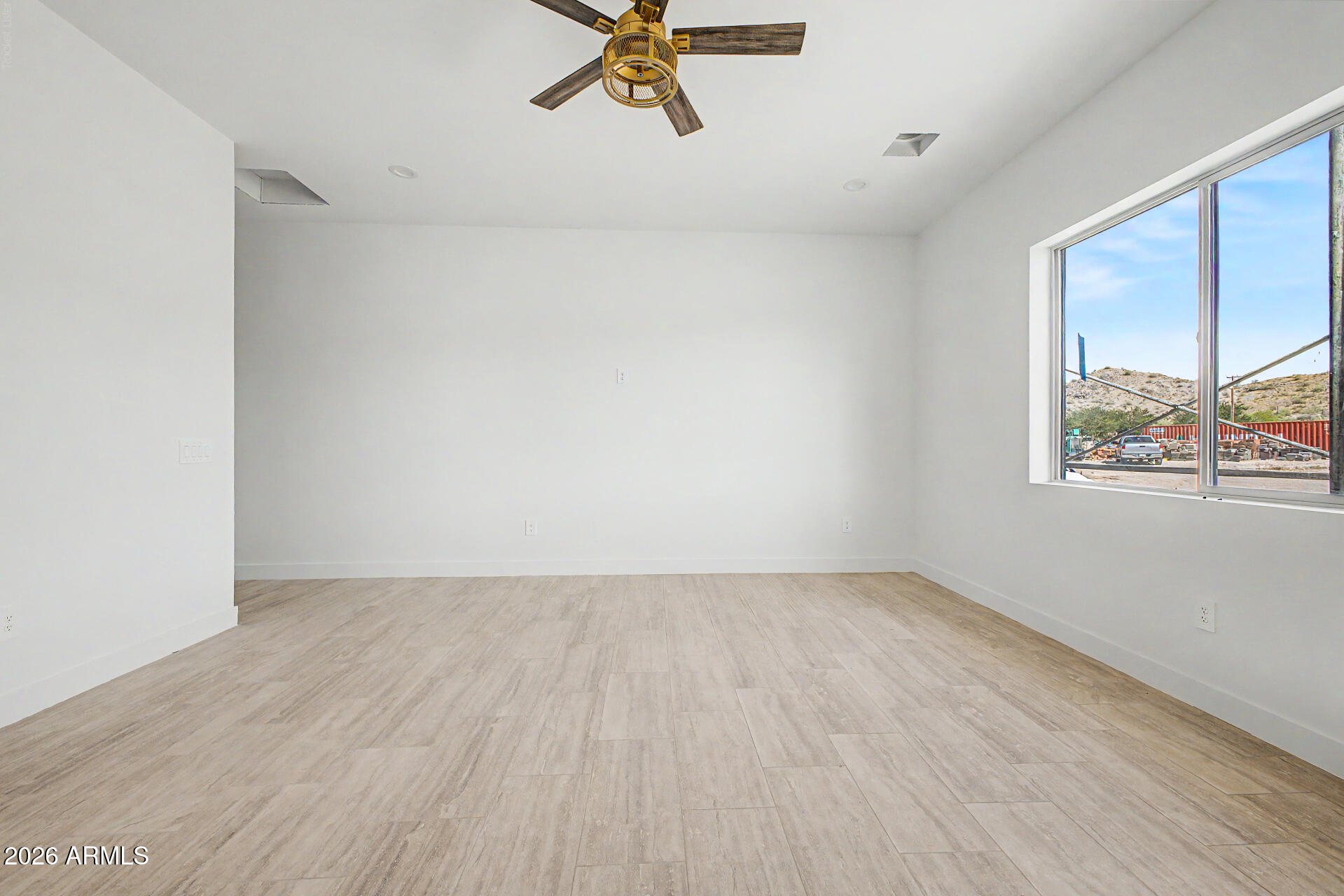 18815 West Arlington Road Buckeye, AZ 85326 - Photo 27 of 56 a view of an empty room with a window