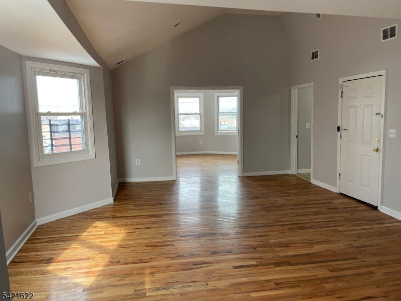 784 South 19th Street, Unit 2 Newark, NJ 07103 - Photo 3 of 11 a view of an empty room with window and wooden floor
