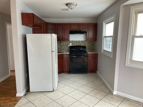 a kitchen with stainless steel appliances a refrigerator and a stove top oven