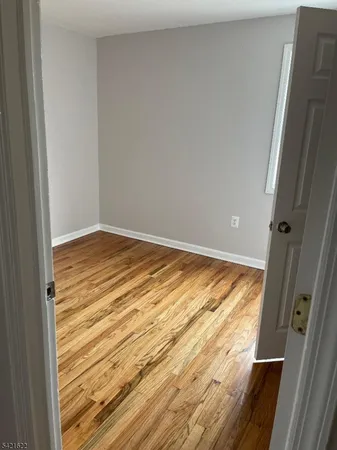 a view of wooden floor and cabinet in an empty room