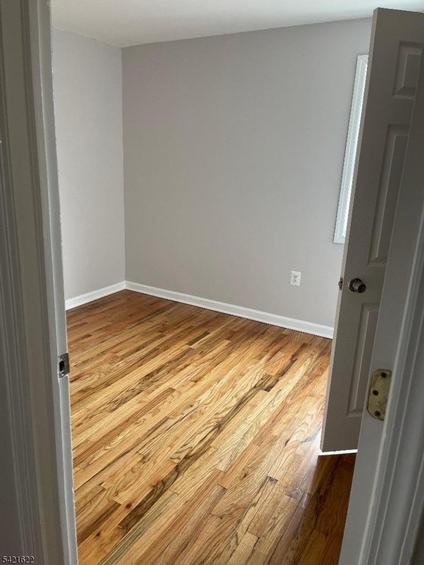 784 South 19th Street, Unit 2 Newark, NJ 07103 - Photo 8 of 11 a view of wooden floor and cabinet in an empty room