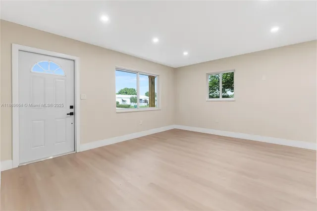 an empty room with windows and closet