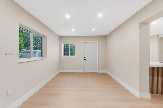 an empty room with wooden floor and closet