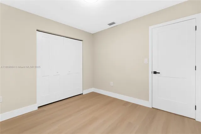 a bathroom with a toilet sink vanity and mirror