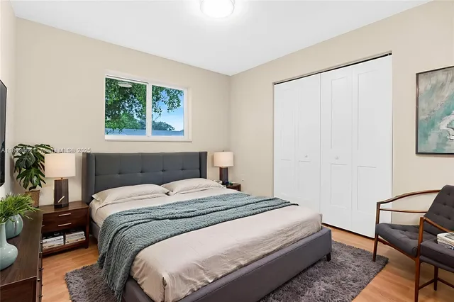 a bedroom with a bed and window