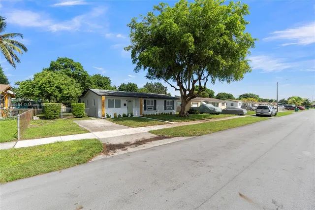 a view of a backyard with large trees