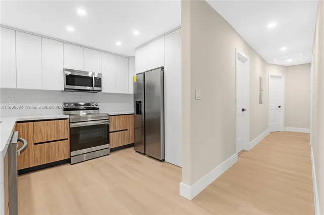 a kitchen with a refrigerator stove and microwave