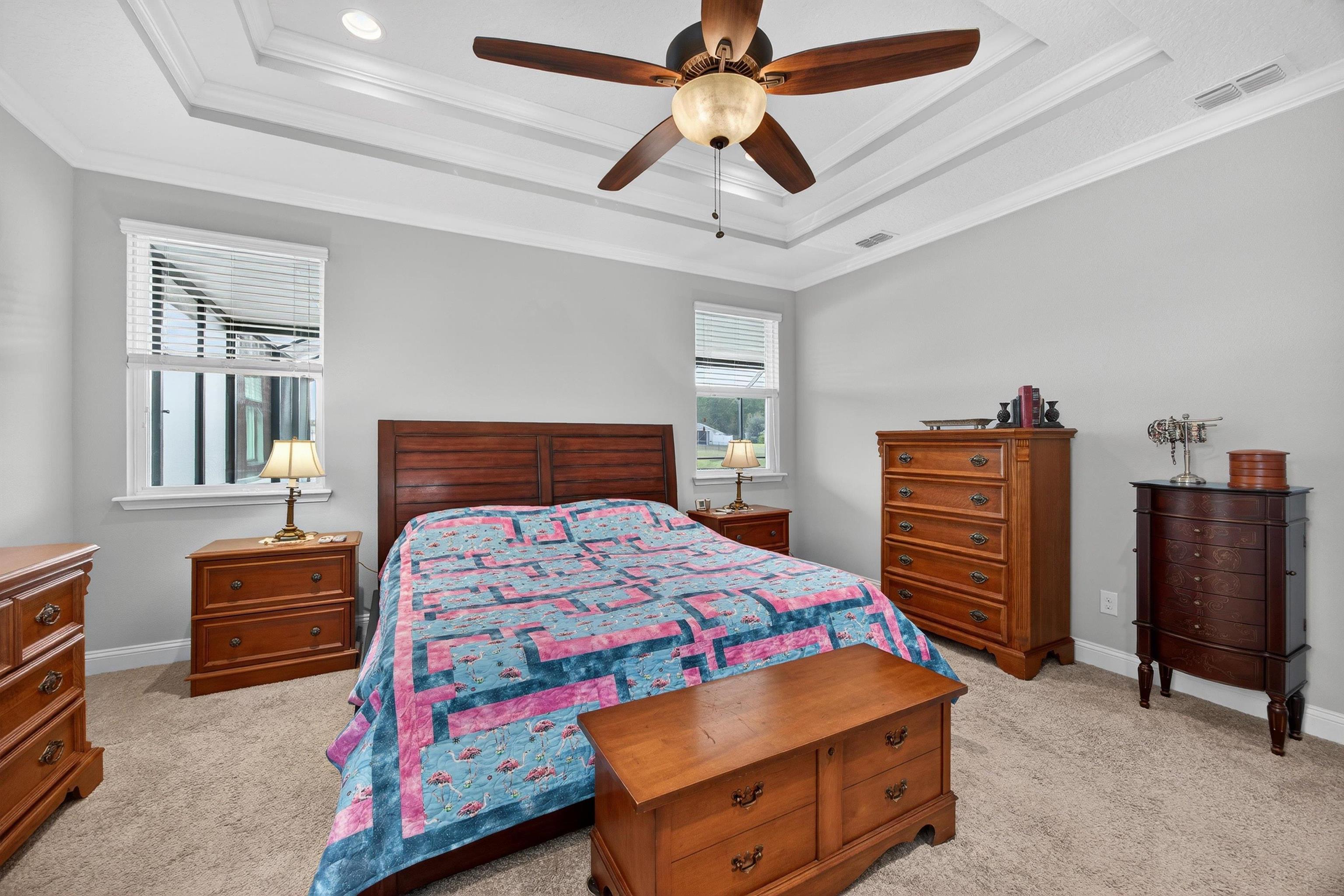 50 Sierras Loop St. Augustine, FL 32086 - Photo 11 of 37 a bedroom with a bed and a chandelier