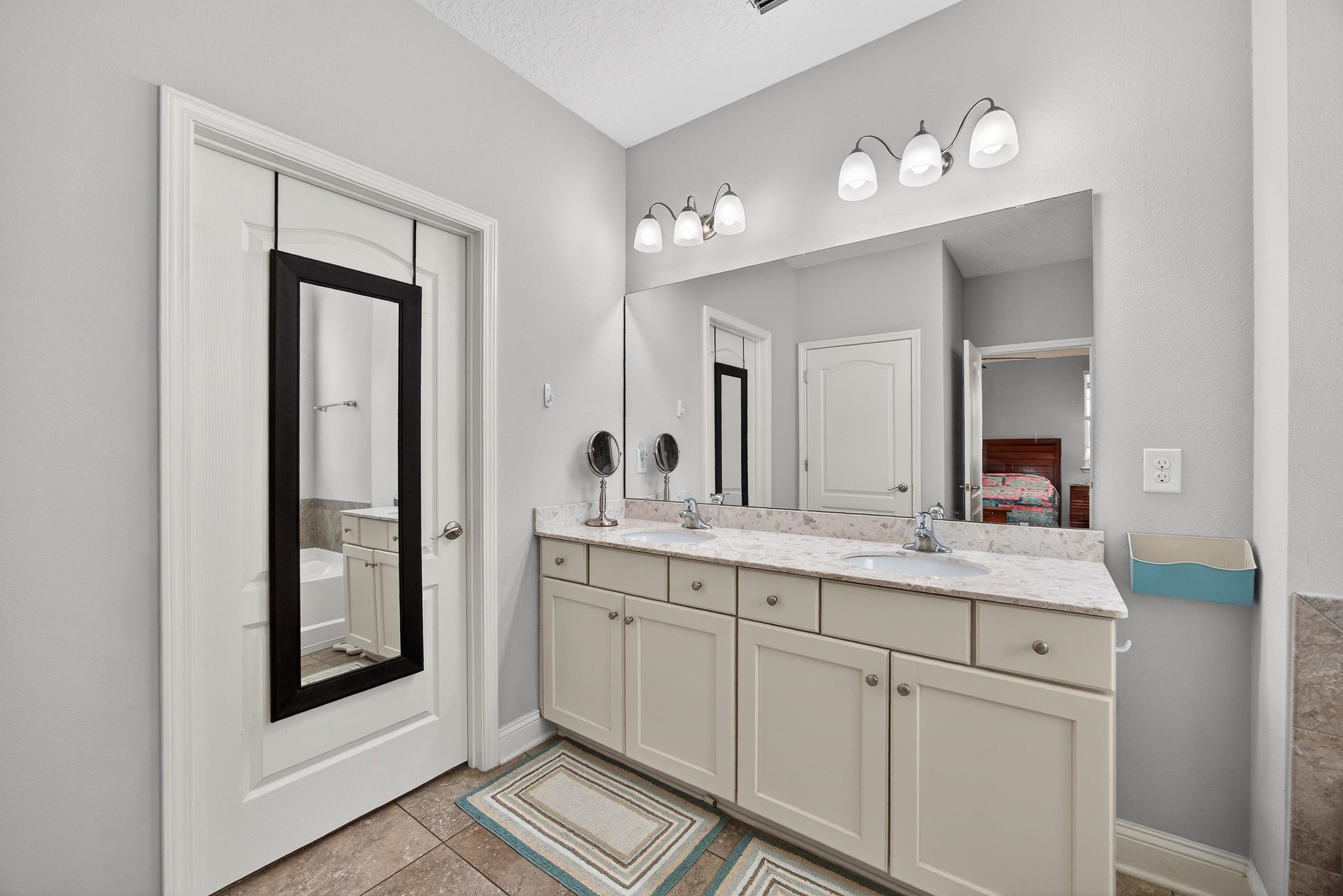 50 Sierras Loop St. Augustine, FL 32086 - Photo 12 of 37 a bathroom with a double vanity sink and a mirror