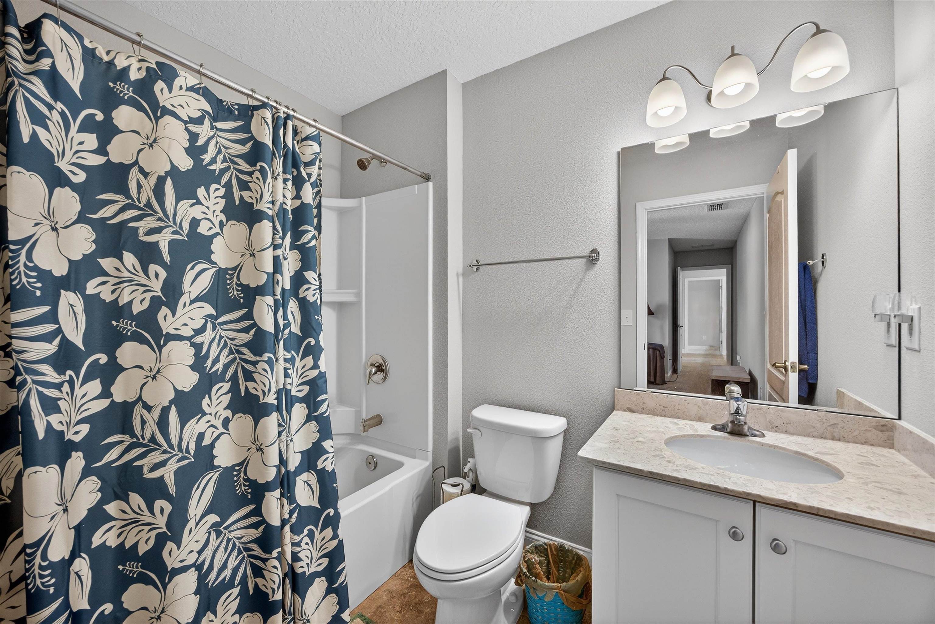 50 Sierras Loop St. Augustine, FL 32086 - Photo 15 of 37 a bathroom with a toilet a sink a mirror and shower curtain