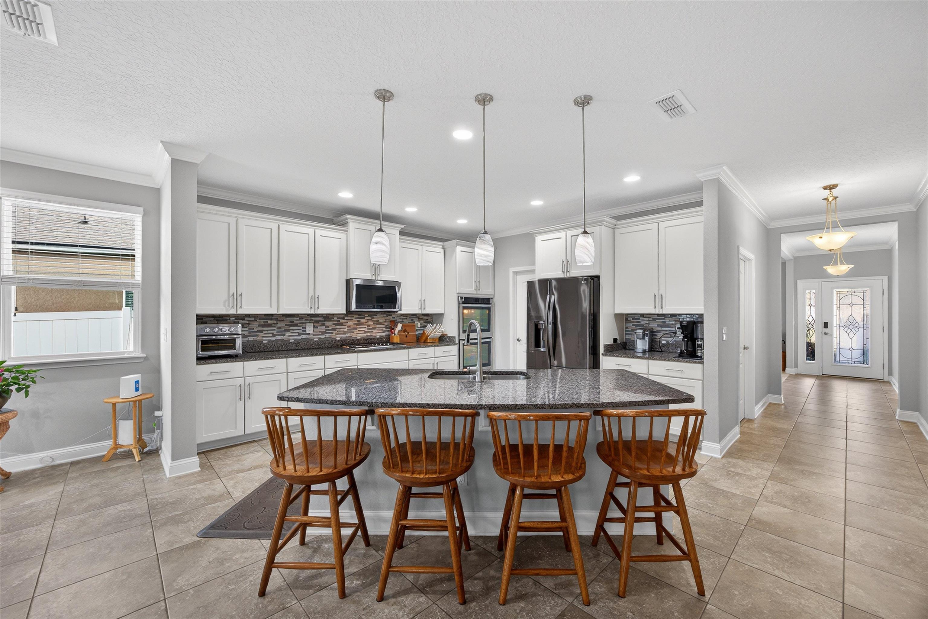 50 Sierras Loop St. Augustine, FL 32086 - Photo 8 of 37 a large kitchen with a table and chairs