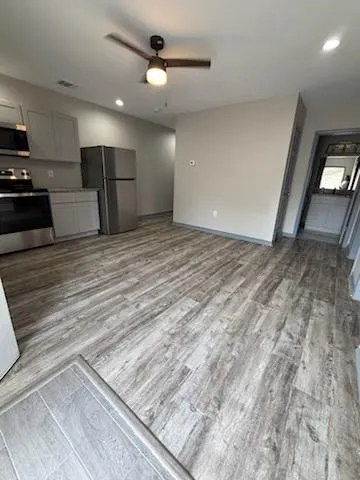 a view of kitchen and empty room