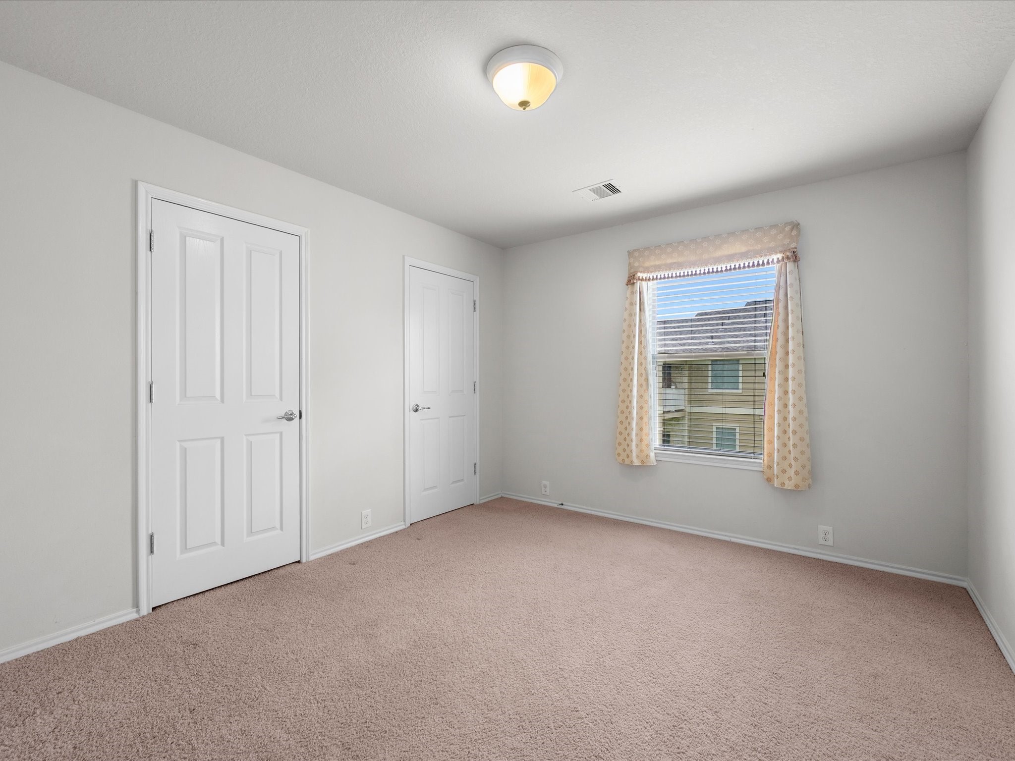 13600 Breton Ridge Street, Unit 31C Houston, TX 77070 - Photo 23 of 31 Equally spacious and filled with natural light, the secondary bedroom offers comfort and versatility for guests, family members, or a home office.