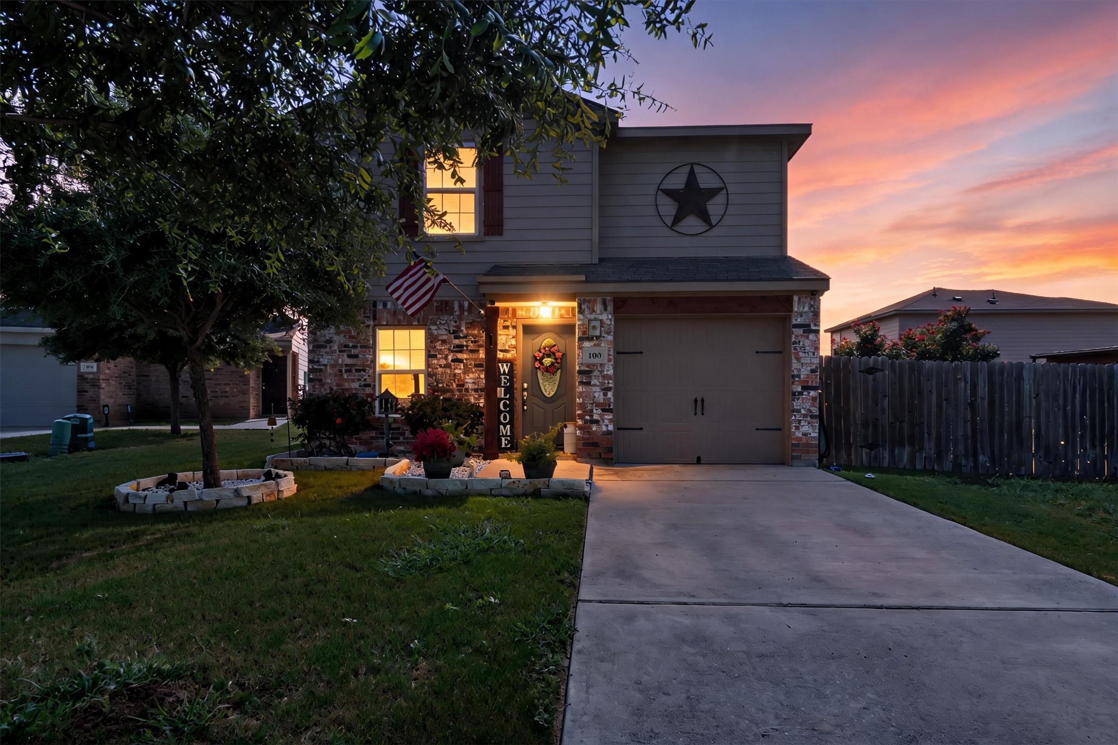 100 Wincliff Cove, Unit 13D Jarrell, TX 76537 - Photo 18 of 21 A welcoming front entrance features brick accents, a garage, and a lush front lawn.