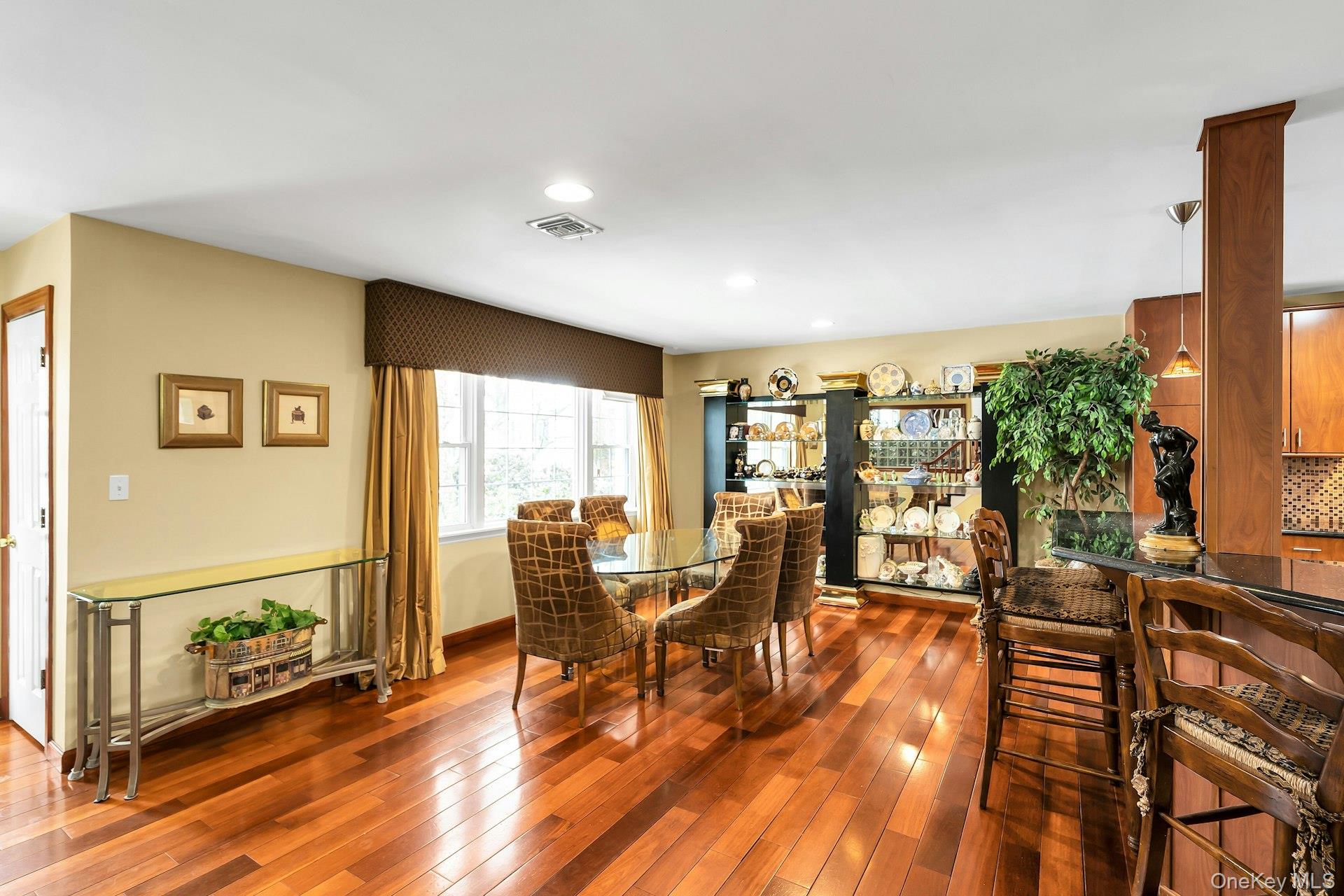 2043 Ripley Lane Merrick, NY 11566 - Photo 11 of 42 a view of a dining room with furniture window and wooden floor