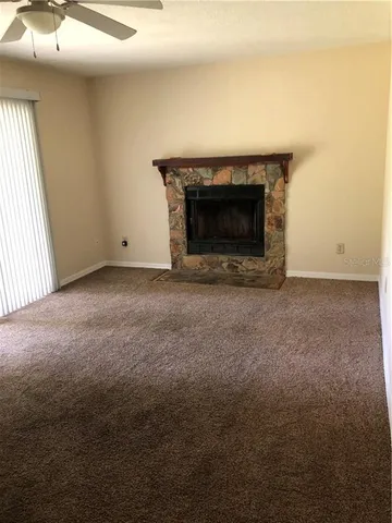 a view of empty room with a fireplace