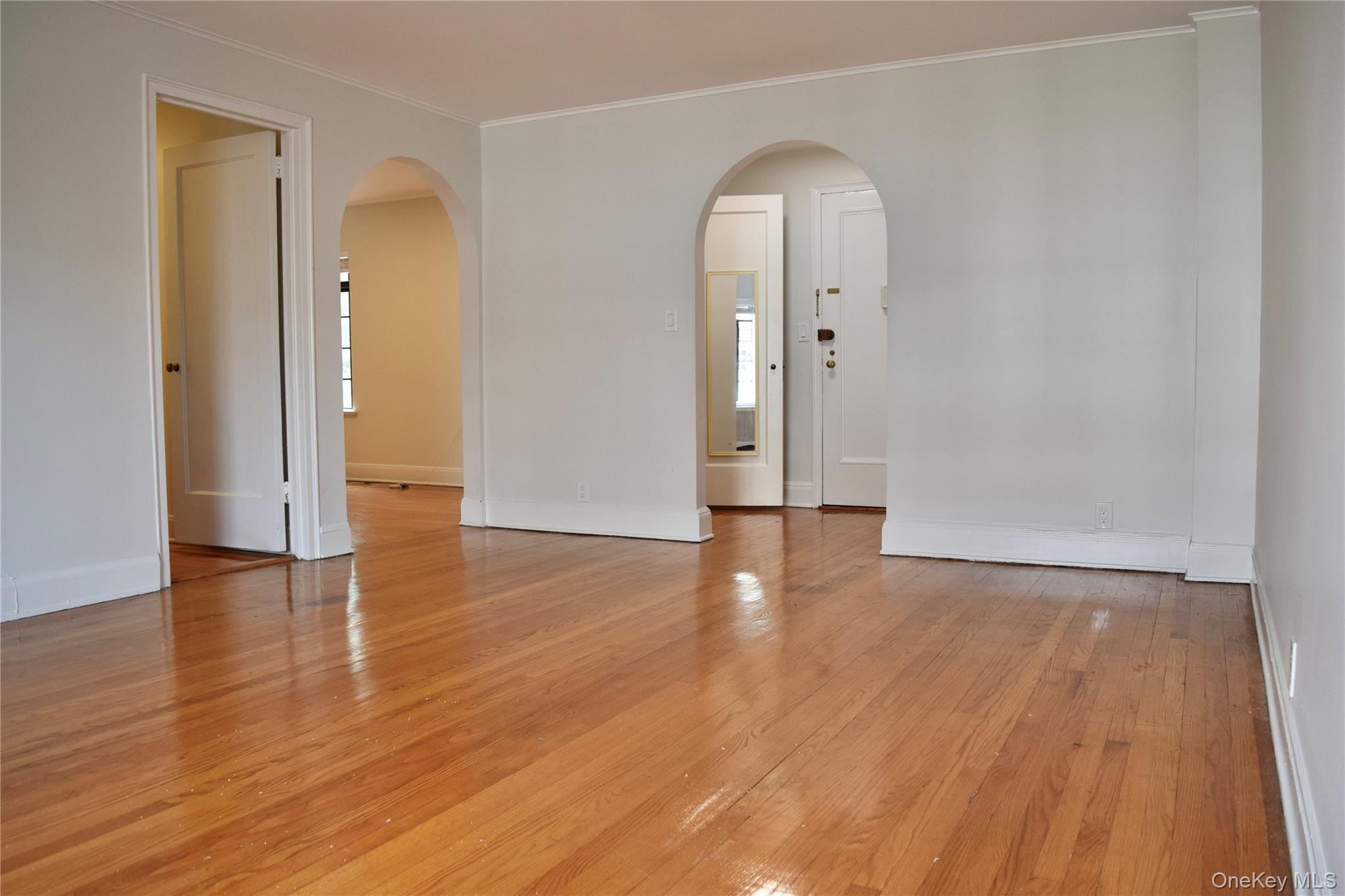 22 Sagamore Road, Unit 2B Bronxville, NY 10708 - Photo 4 of 26 Living Room with arched passageways to entry and dining/kitchen rooms.