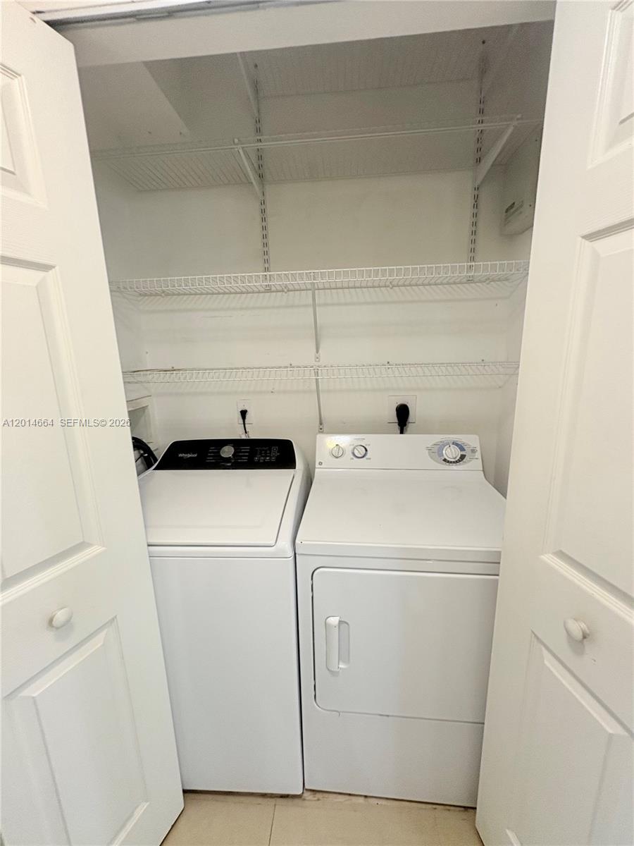 8030 North Nob Hill Road, Unit 105 Tamarac, FL 33321 - Photo 16 of 22 a utility room with dryer and washer