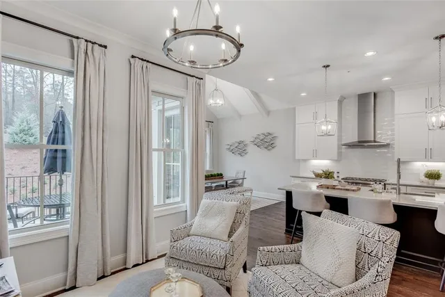 a living room with kitchen island granite countertop furniture and a fireplace