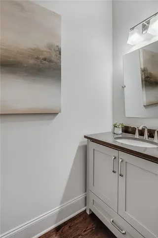 a spacious bedroom with a bed a couch and a large window