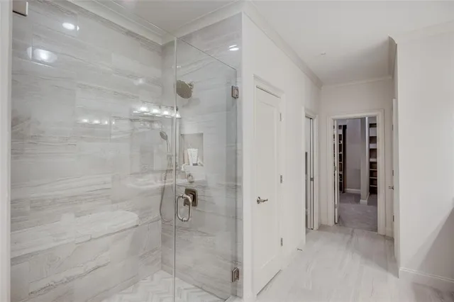 a view of walk in closet with empty racks