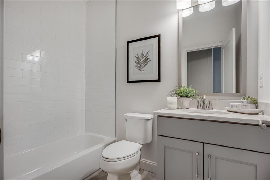 3450 Commander Cove Suwanee, GA 30024 - Photo 31 of 51 a bathroom with a toilet sink and mirror