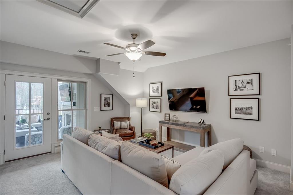 3450 Commander Cove Suwanee, GA 30024 - Photo 32 of 51 a living room with furniture and a flat screen tv