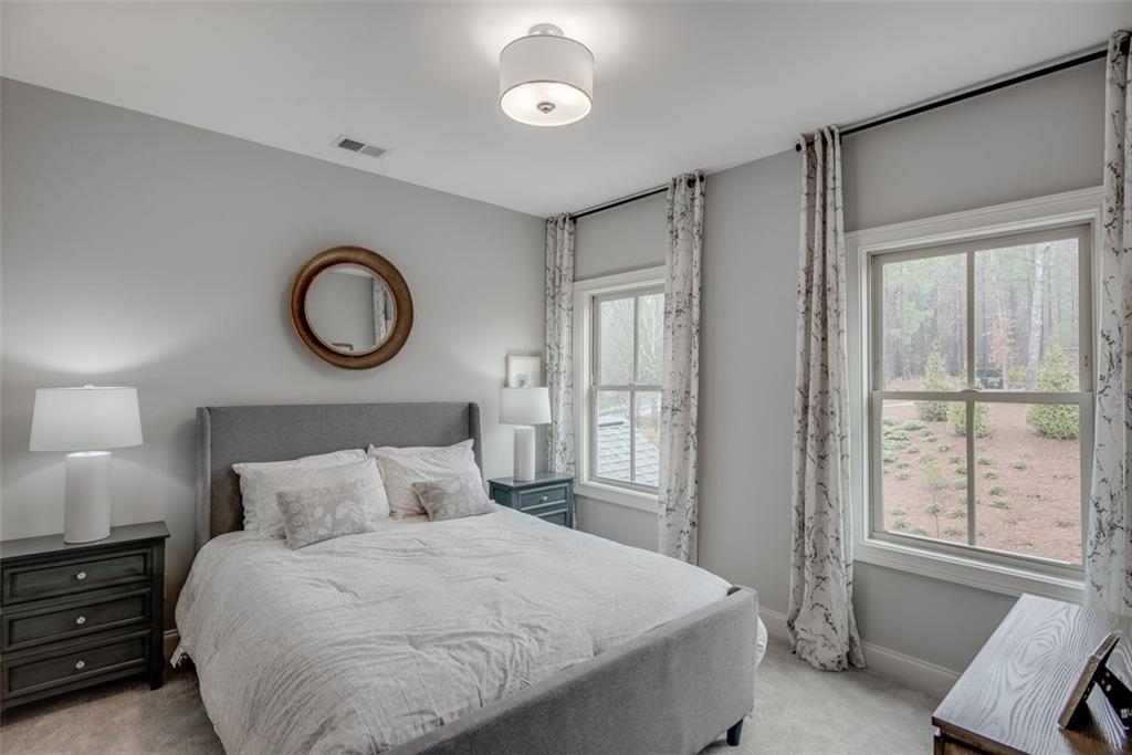 3450 Commander Cove Suwanee, GA 30024 - Photo 32 of 53 a bedroom with a bed and a window