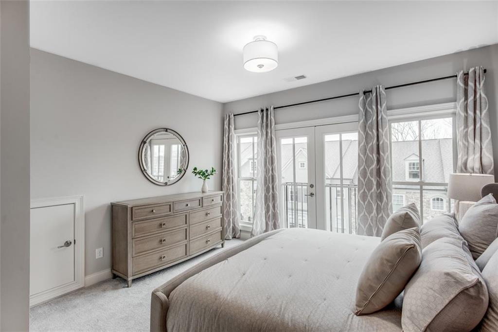 3450 Commander Cove Suwanee, GA 30024 - Photo 35 of 51 a bedroom with a large bed and a large window