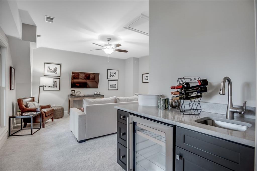 3450 Commander Cove Suwanee, GA 30024 - Photo 36 of 53 a kitchen with a sink cabinets and wooden floor