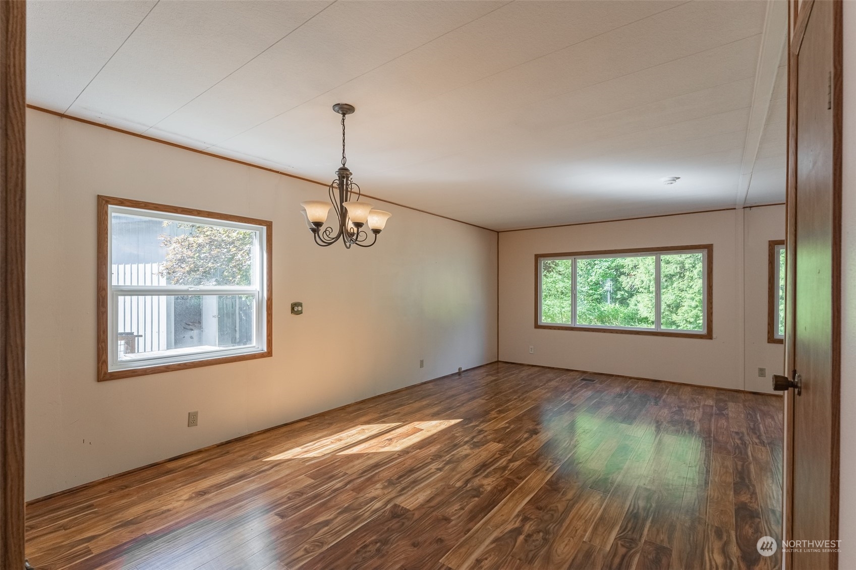 1069 East Axton Road Bellingham, WA 98226 - Photo 12 of 33 an empty room with wooden floor windows and entrance