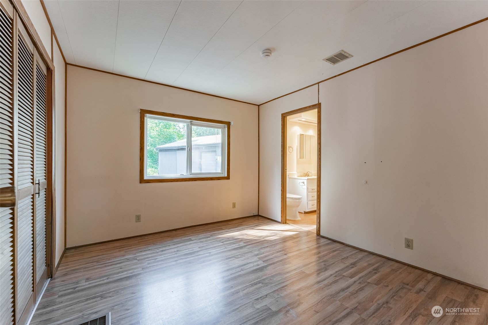 1069 East Axton Road Bellingham, WA 98226 - Photo 21 of 33 an empty room with wooden floor and windows