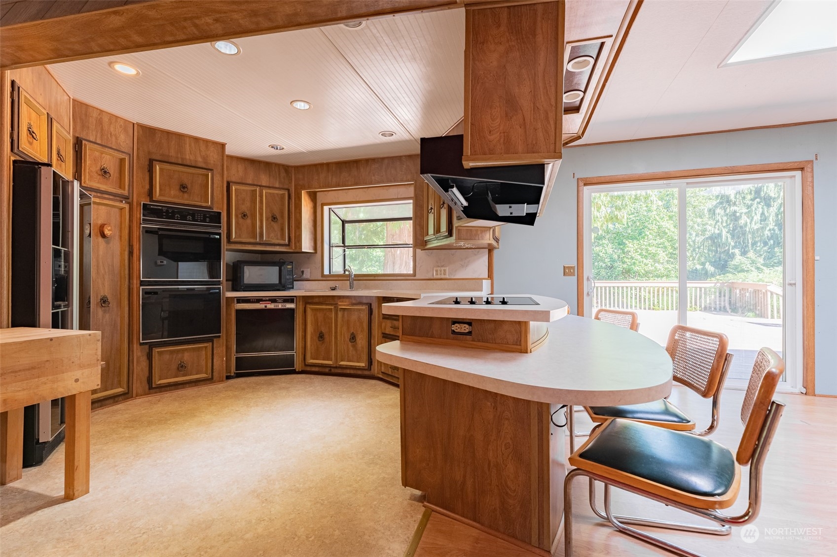 1069 East Axton Road Bellingham, WA 98226 - Photo 7 of 33 a kitchen with stainless steel appliances a stove a sink refrigerator and a chair