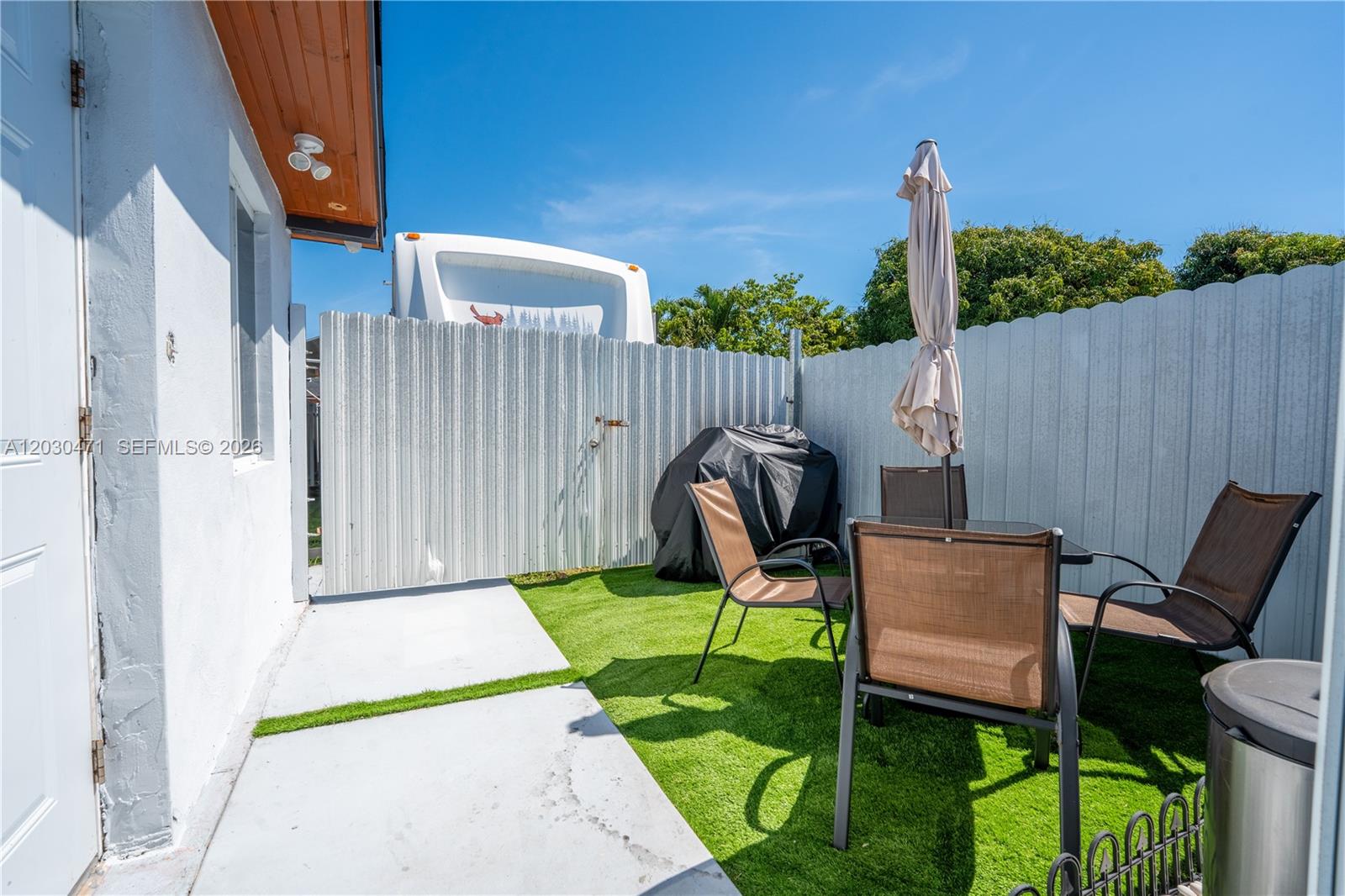 11851 Southwest 181st Street Miami, FL 33177 - Photo 22 of 25 a view of a chair and table in backyard of the house