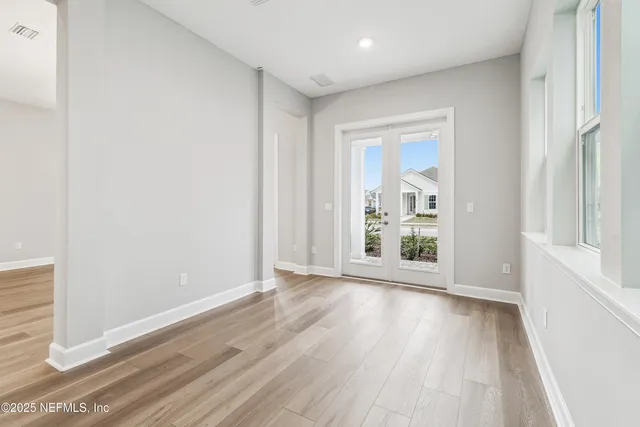 a view of a hallway with wooden floor