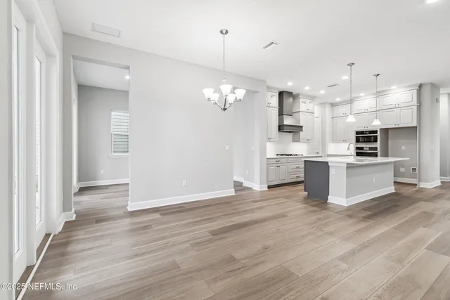 a kitchen with stainless steel appliances granite countertop a sink stove and microwave