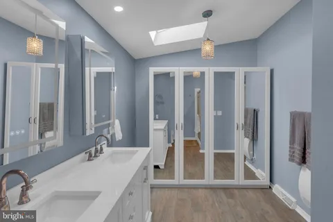 a bathroom with a sink and mirror