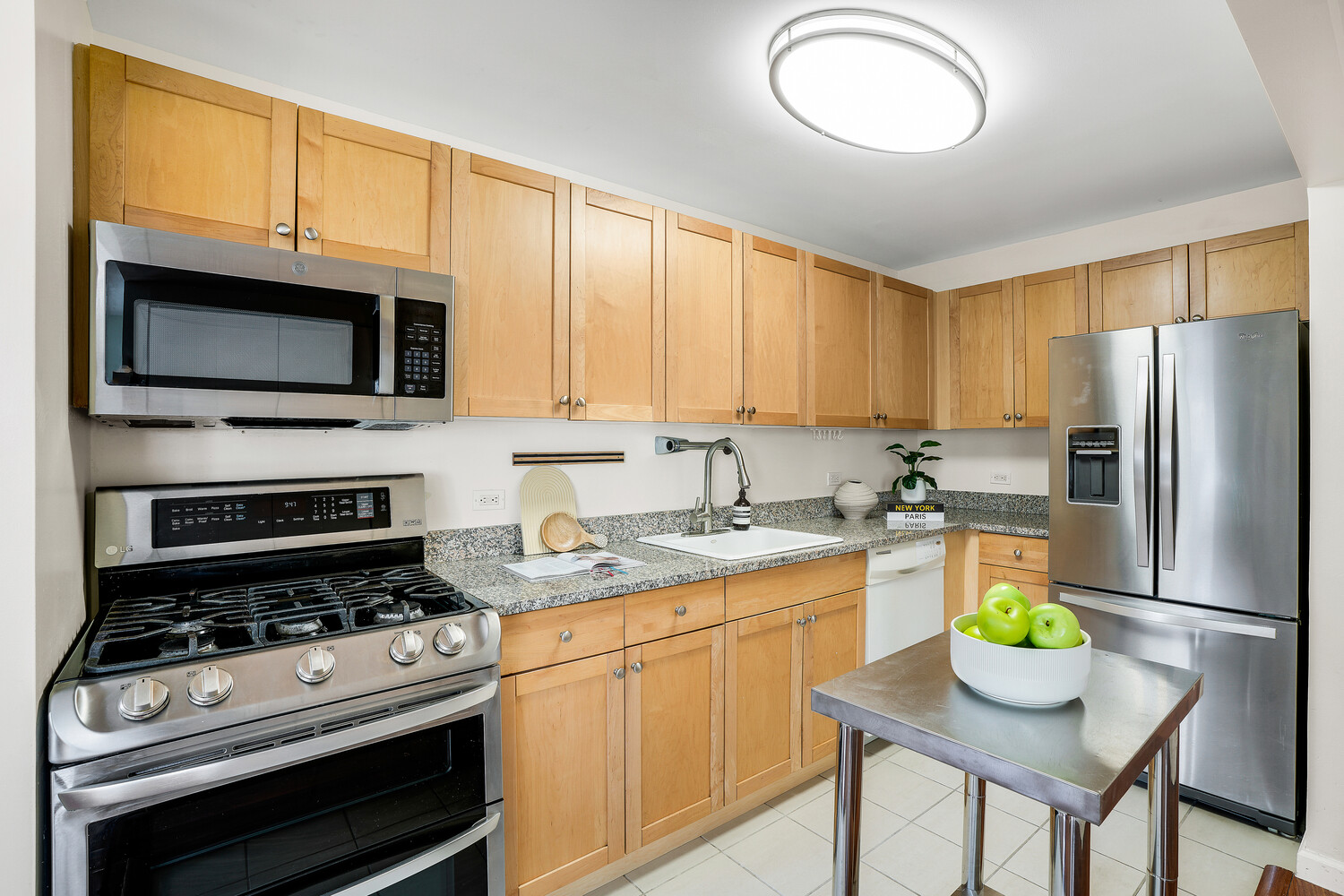 300 West 145th Street, Unit 1K Manhattan, NY 10039 - Photo 11 of 28 a kitchen with stainless steel appliances granite countertop a stove refrigerator and a microwave